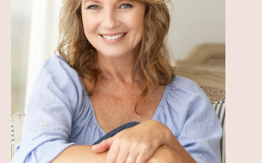A portrait of a smiling woman seated indoors